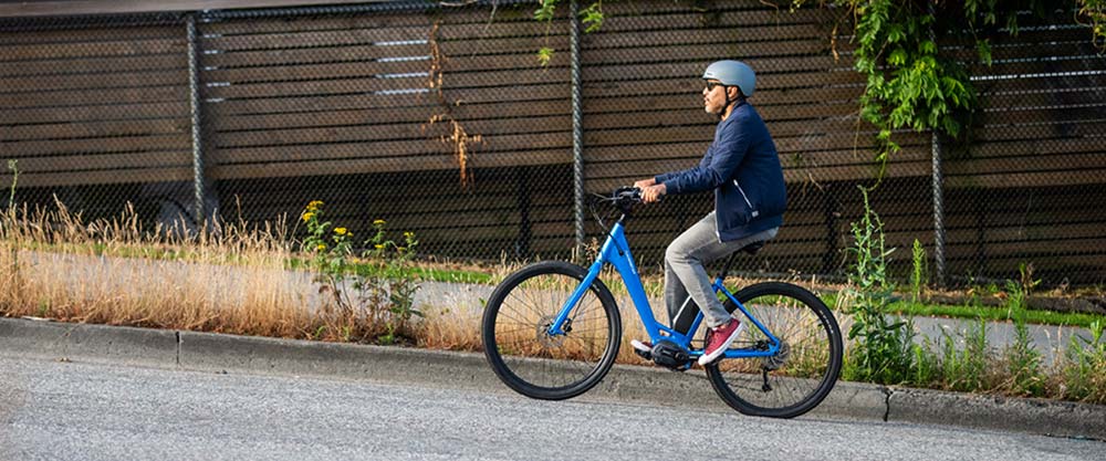 Cyclist riding uphill on an electric cruiser bike