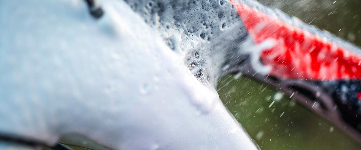 Close up of bike being washed with foam bike wash