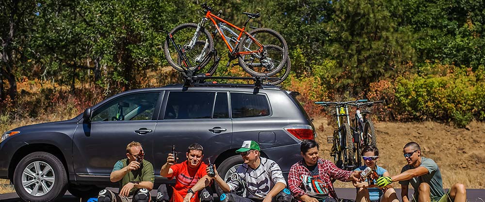 Friends sitting in front of their car with Yakima roof car rack