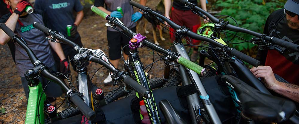 Friends drinking around Yakima ute mount with bikes