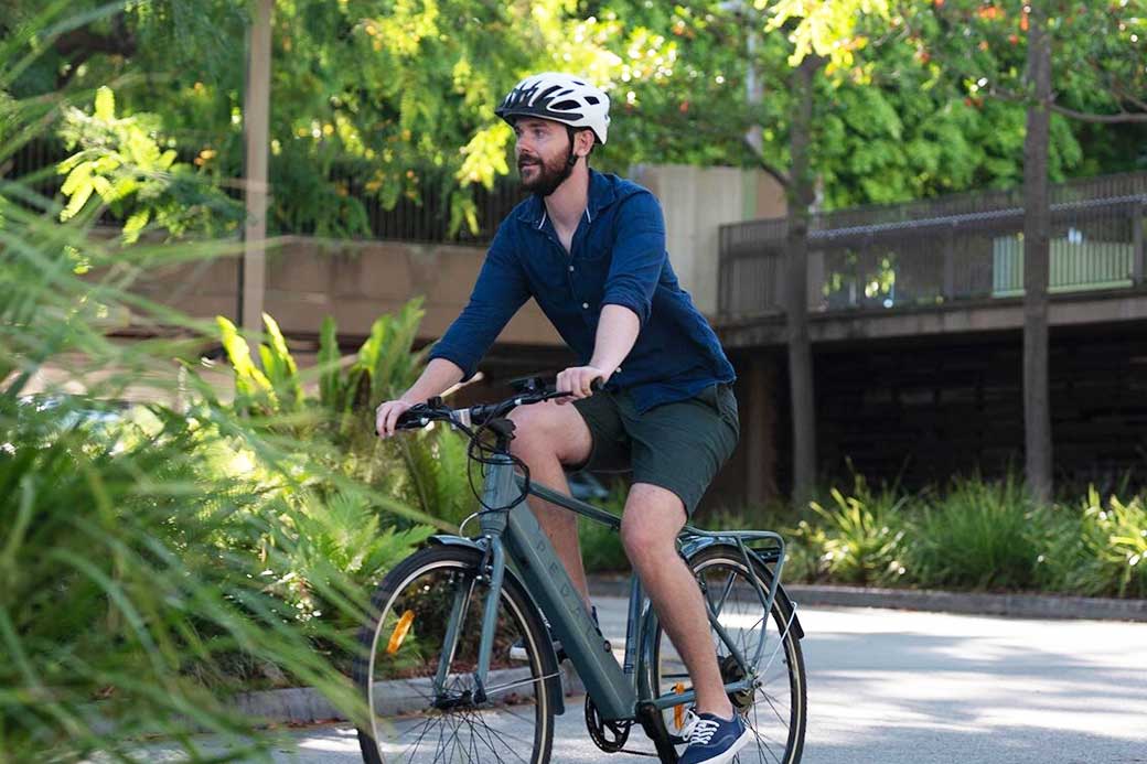 cyclist riding electric bike through city