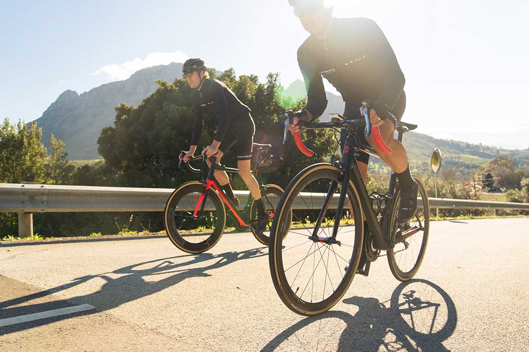 Two road cyclists riding uphill on Silverback road bikes